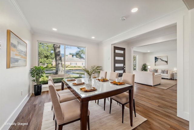 dining room with crown molding and wood-type flooring