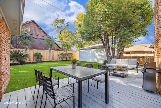 deck with outdoor lounge area and a yard