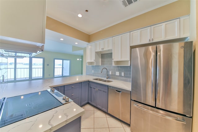 kitchen with gray cabinets, stainless steel appliances, white cabinetry, and sink