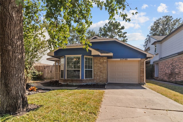 view of front facade with a front yard and a garage