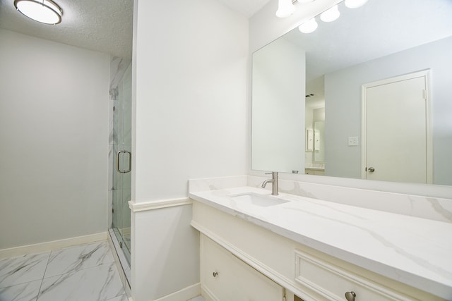 bathroom featuring vanity, a textured ceiling, and walk in shower