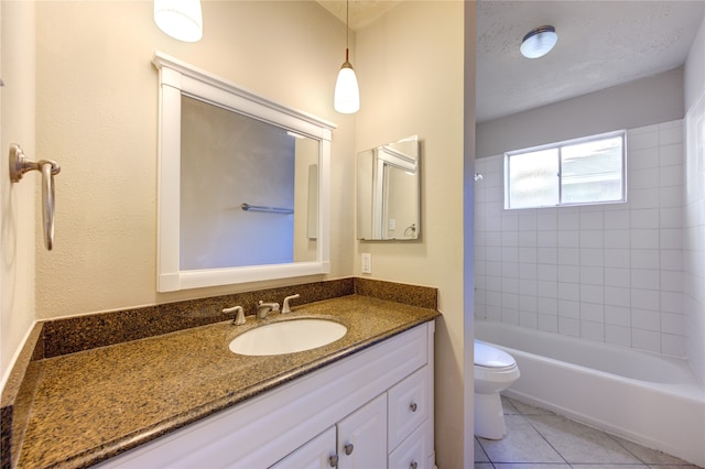 full bathroom featuring tile patterned floors, vanity, a textured ceiling, toilet, and tiled shower / bath