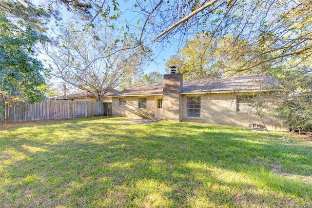 rear view of house with a yard