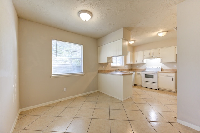 kitchen featuring white cabinetry, light tile patterned floors, white appliances, and a wealth of natural light