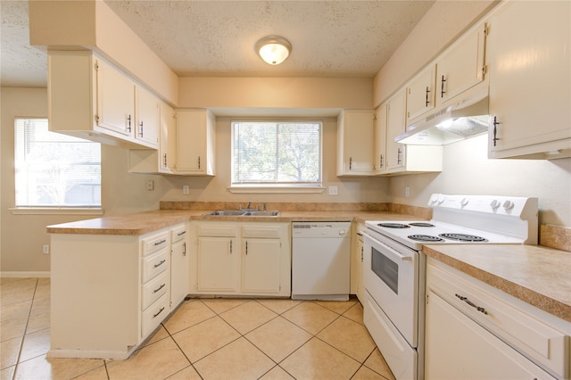 kitchen with white cabinetry, a wealth of natural light, and white appliances