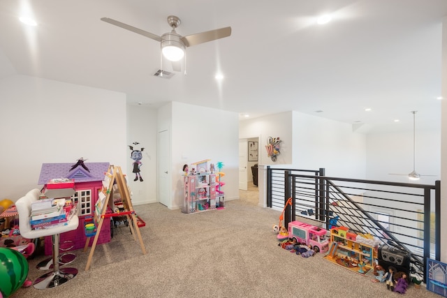 rec room with ceiling fan and carpet