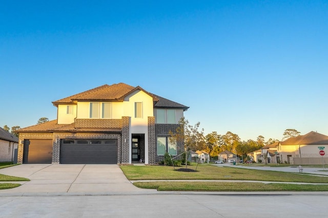 view of front of home featuring a front yard and a garage