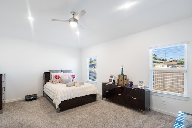 carpeted bedroom featuring ceiling fan and multiple windows