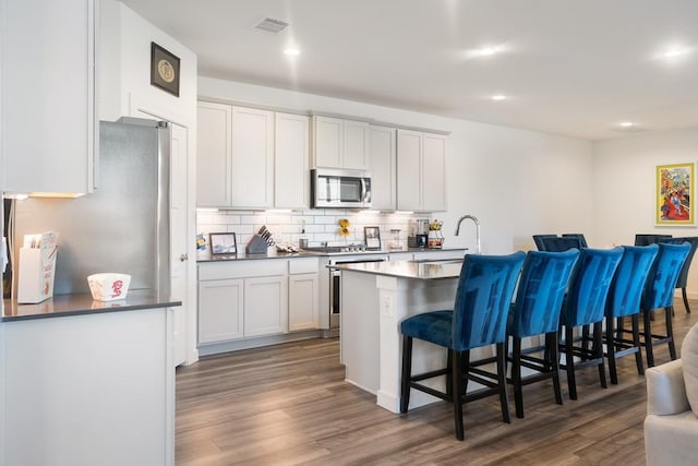 kitchen featuring white cabinets, appliances with stainless steel finishes, and sink