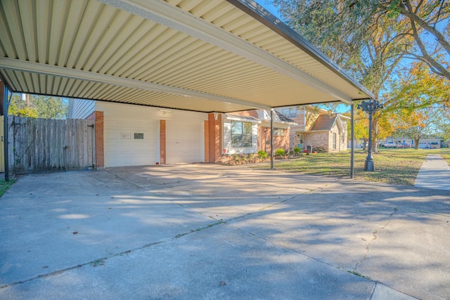 view of patio / terrace featuring a garage and a carport