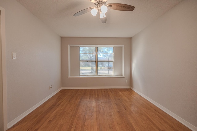 spare room featuring ceiling fan and light hardwood / wood-style floors