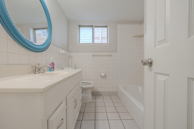 bathroom featuring tile patterned floors, vanity, tile walls, and toilet