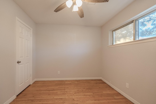 empty room with ceiling fan and light hardwood / wood-style floors