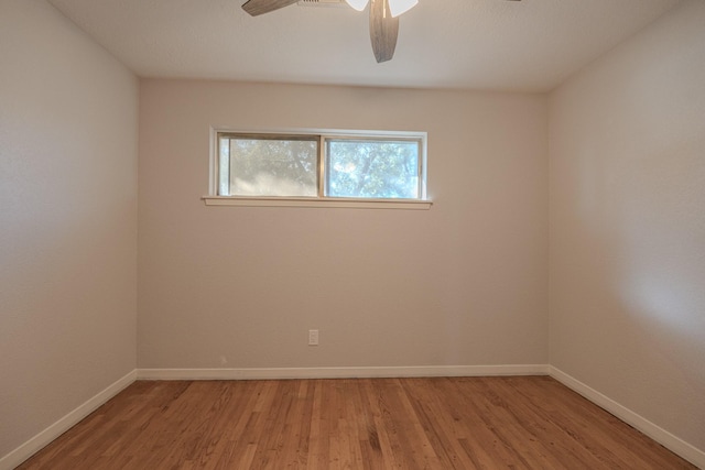 unfurnished room featuring ceiling fan and hardwood / wood-style floors