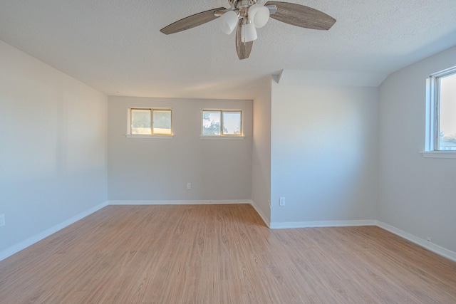 unfurnished room with a textured ceiling, light hardwood / wood-style flooring, and ceiling fan