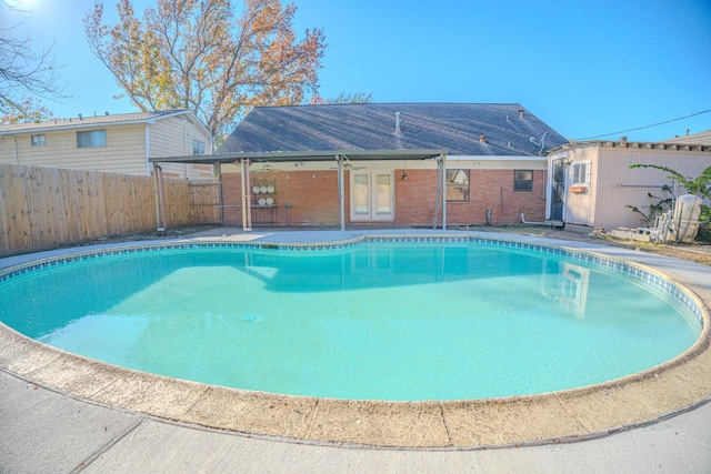 view of pool featuring french doors and a patio area