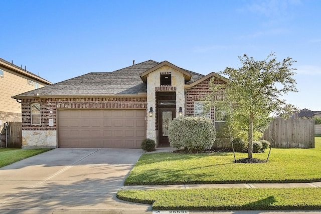 view of front of property with a garage and a front lawn