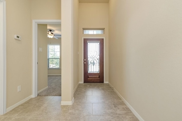 tiled foyer with ceiling fan and a wealth of natural light