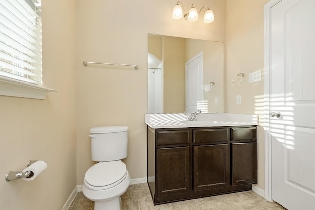 bathroom featuring tile patterned floors, vanity, and toilet