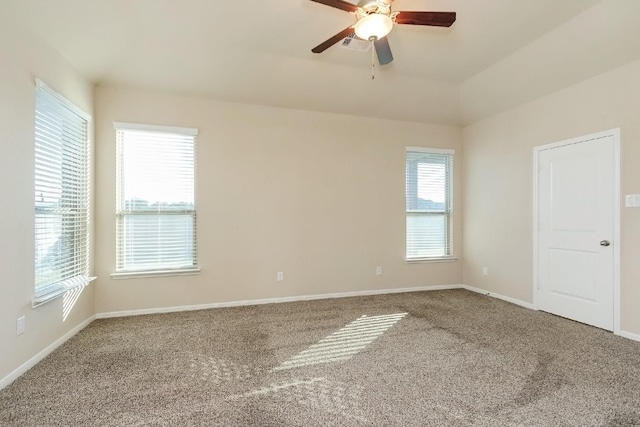 carpeted empty room with a wealth of natural light and ceiling fan