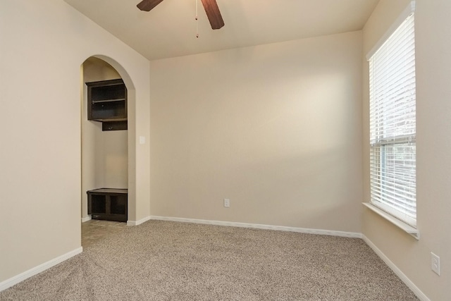 empty room with ceiling fan and carpet floors