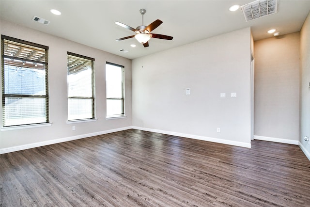 spare room featuring ceiling fan and dark hardwood / wood-style flooring