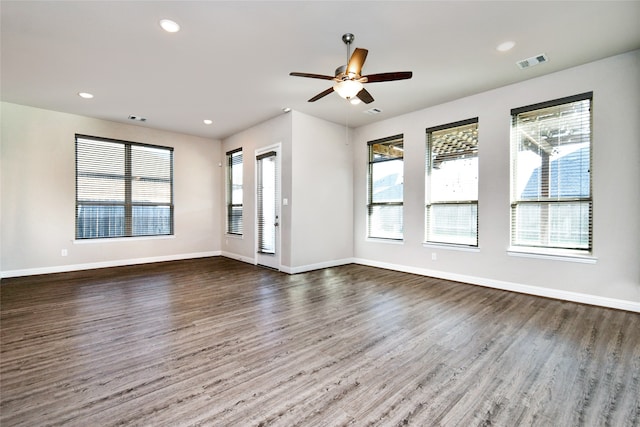 unfurnished living room with dark wood-type flooring and ceiling fan