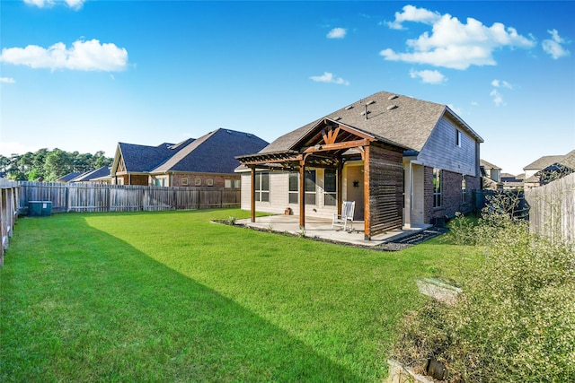 back of property with a yard and a patio