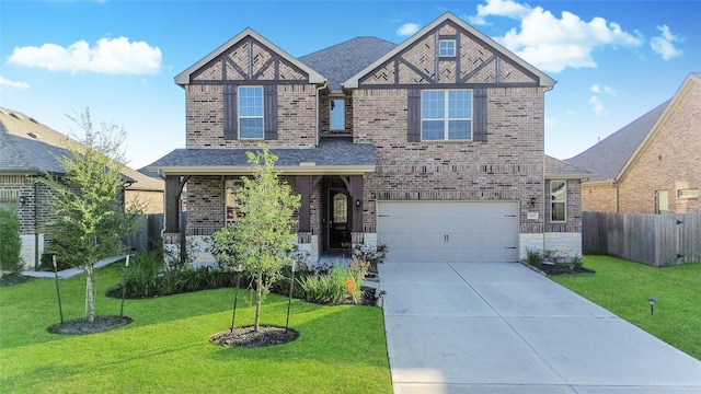 view of front of property with a front yard and a garage