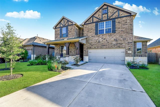 view of front of property with a garage, a front yard, and covered porch