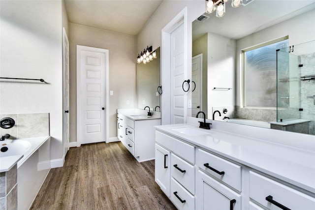 bathroom with vanity, hardwood / wood-style floors, and independent shower and bath