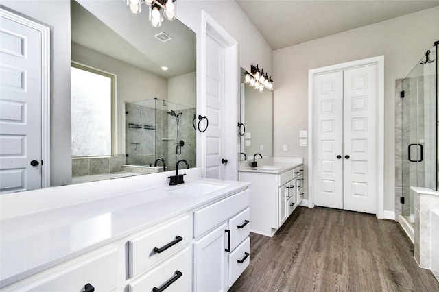 bathroom featuring an enclosed shower, vanity, and hardwood / wood-style flooring