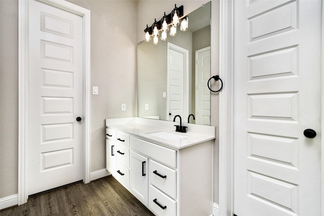 bathroom featuring hardwood / wood-style flooring and vanity