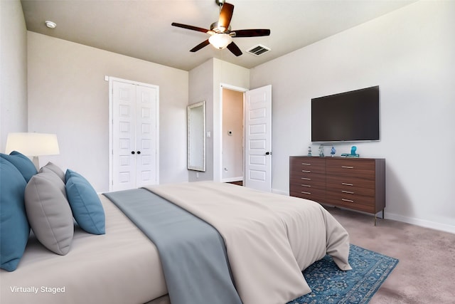 carpeted bedroom featuring a closet and ceiling fan