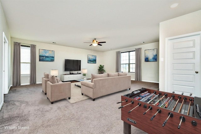 carpeted living room featuring ceiling fan