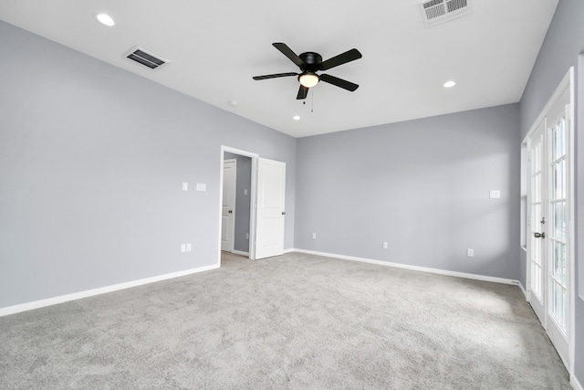 spare room with ceiling fan, plenty of natural light, and carpet floors