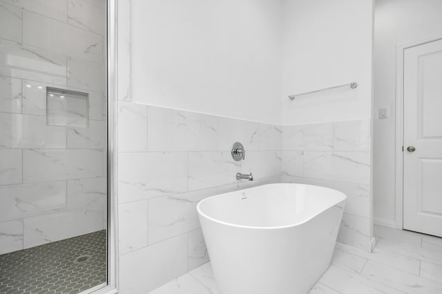 bathroom with plus walk in shower and tile walls