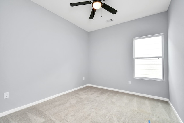 carpeted empty room featuring ceiling fan