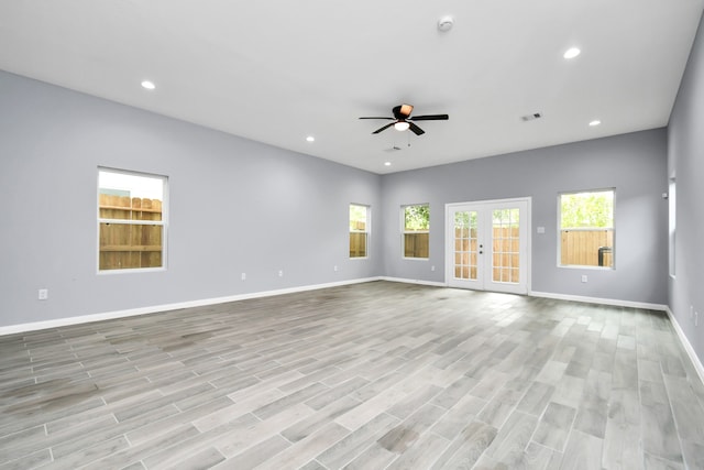 unfurnished living room featuring ceiling fan and light wood-type flooring