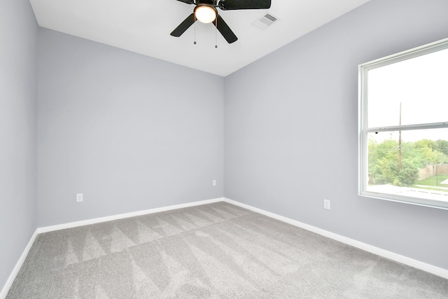 carpeted spare room featuring ceiling fan