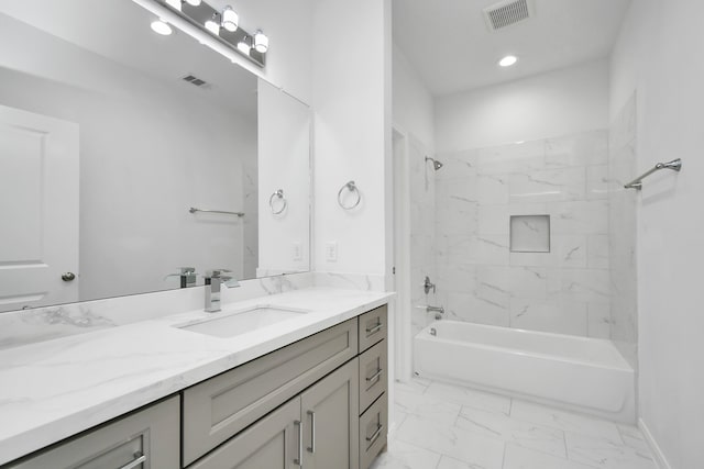 bathroom featuring vanity and tiled shower / bath combo