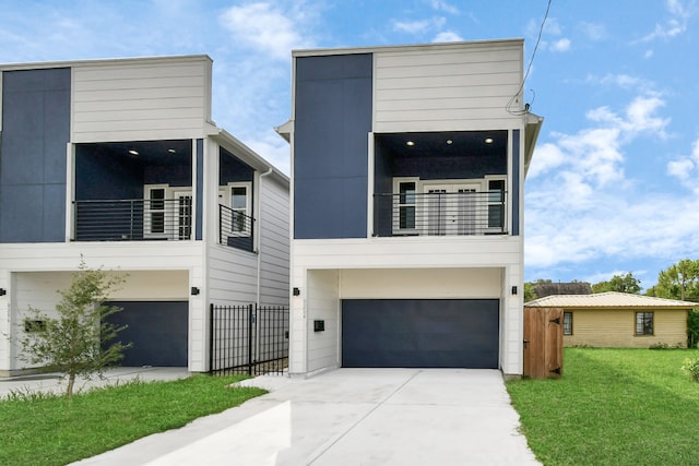 contemporary house with a balcony, a front lawn, and a garage