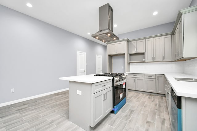 kitchen with gray cabinetry, island range hood, appliances with stainless steel finishes, and light hardwood / wood-style flooring