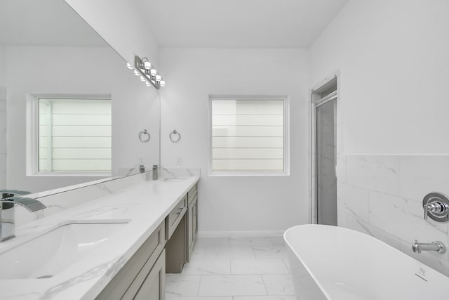 bathroom featuring shower with separate bathtub and vanity