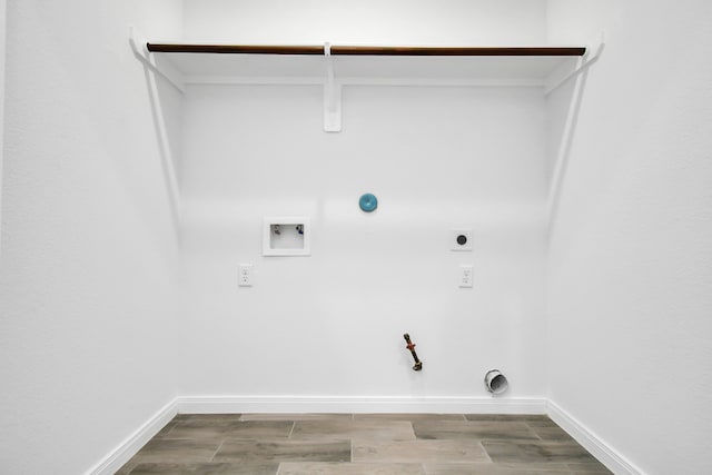 laundry room featuring electric dryer hookup, gas dryer hookup, washer hookup, and light hardwood / wood-style floors