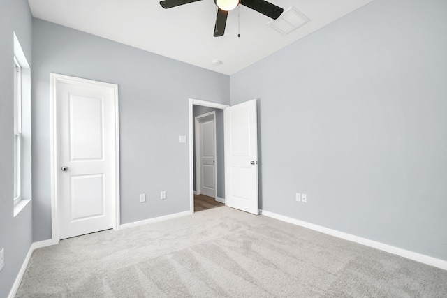 unfurnished bedroom with ceiling fan and light carpet