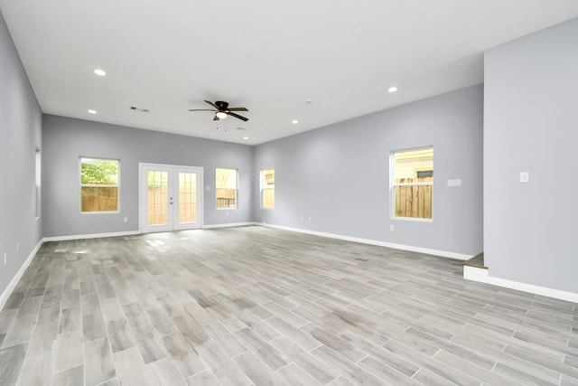 unfurnished living room featuring french doors, light hardwood / wood-style flooring, and ceiling fan