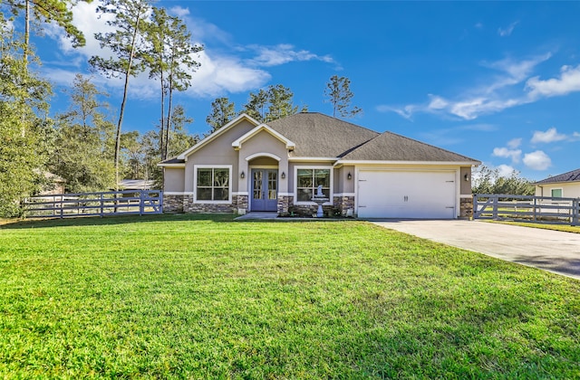 view of front of property with french doors, a garage, and a front lawn