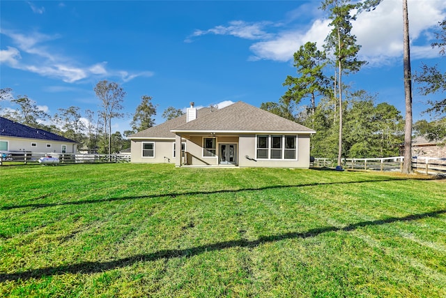 rear view of house with a yard