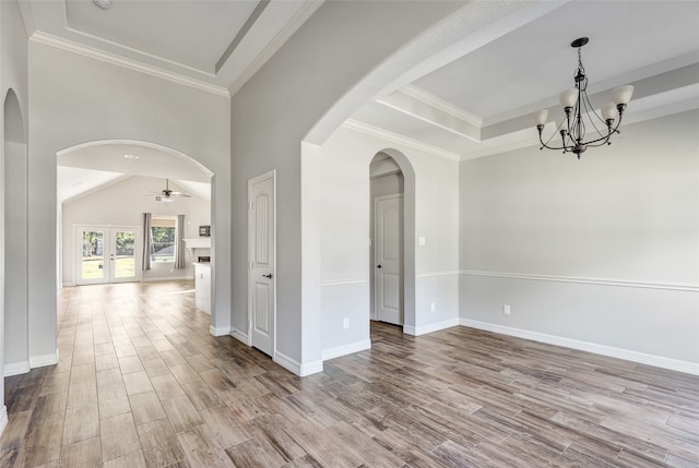 spare room with light hardwood / wood-style flooring, ceiling fan with notable chandelier, and ornamental molding